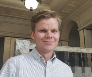Kuvassa Vasemmisto-opiskelijoiden varapuheenjohtaja Aku Houttu, joka hymyilee